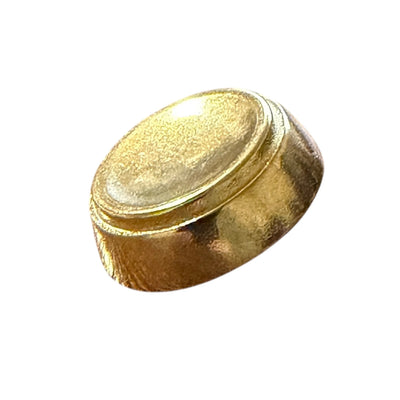 Flat gold metal button with a polished surface, side view, for shirts and waistcoats